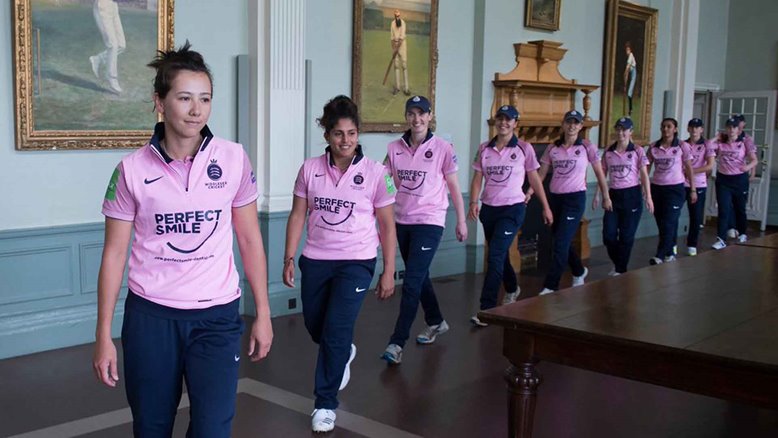 Middlesex Women walk through the Long Room.